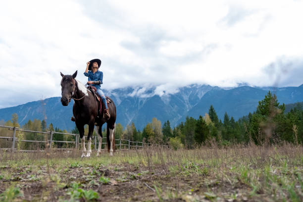 istock Woman riding her horse at a ranch 1345073967