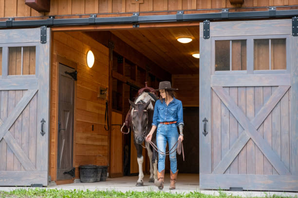 istock Female rancher working with her horse 1345074280
