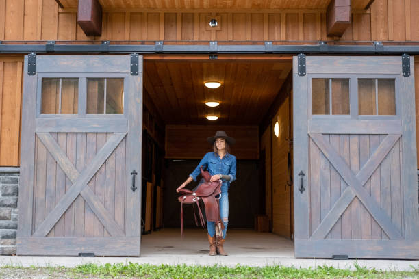 istock Female rancher working with her horse 1345075115