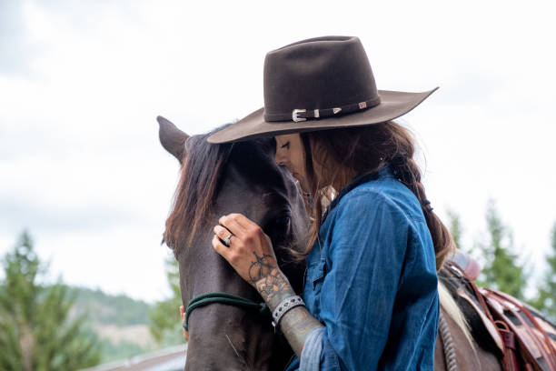 istock Female rancher working with her horse 1345075186
