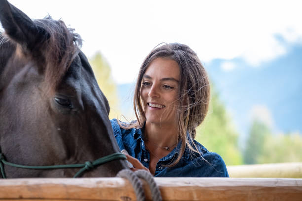 istock Female rancher working with her horse 1345075292