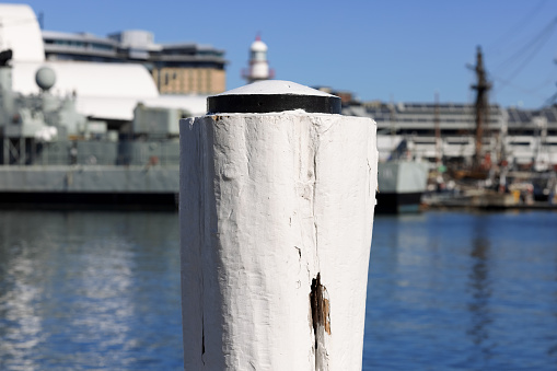 White post on a wharf showing signs of wear.