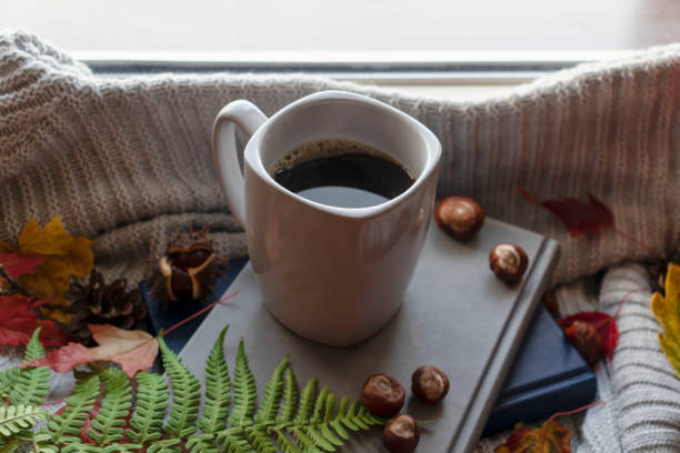 istock Autumn coffee in a gray cup on the window. 1345075791