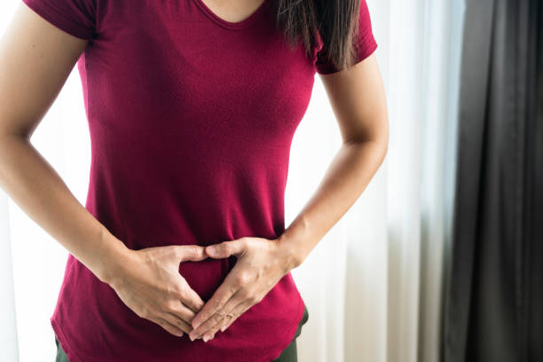 woman having painful stomachache at home. Chronic gastritis. Abdomen bloating concept woman having painful stomachache at home. Chronic gastritis. Abdomen bloating concept pms stock pictures, royalty-free photos & images