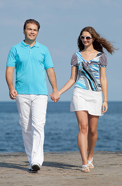 Young man and young woman on seashore