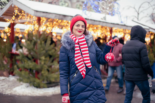 istock Young woman on Christmas market. 1345079270