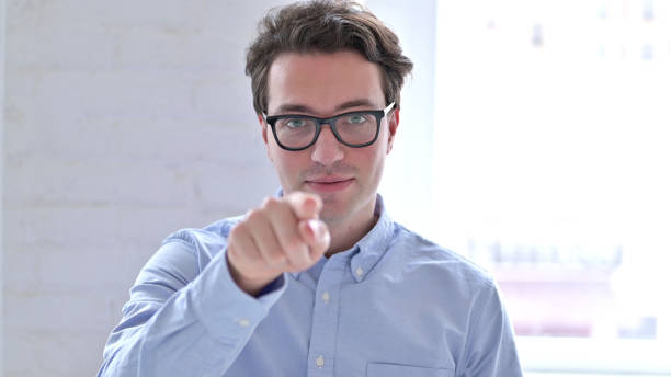 istock Portrait of Young Man Pointing with Finger 1345079985