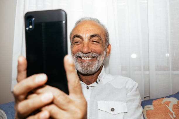 istock old man making video call with his smartphone 1345081348