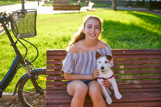 Free Stock Photo of Young happy girl with her cute dog on a park bench ...