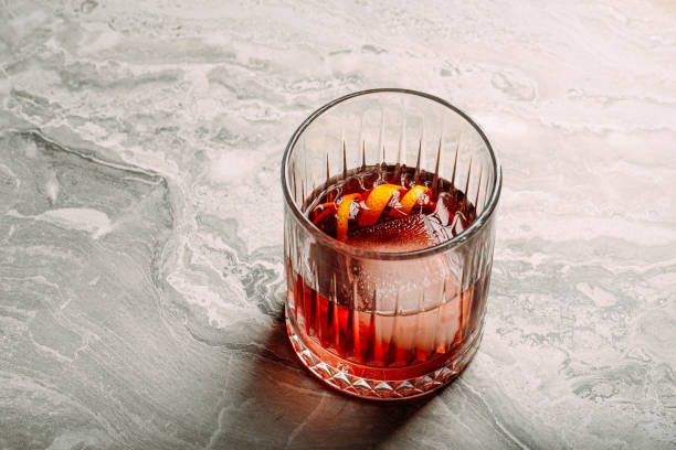 Closeup negroni cocktail in old fashion glass Closeup on negroni cocktail in old fashioned glass on marble background vermouth stock pictures, royalty-free photos & images