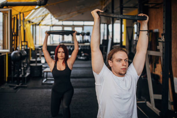 istock Man and woman training in gym 1345086140
