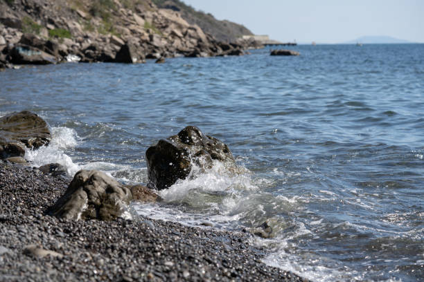 istock Splashes from the waves bumping against the rocky shore 1345087028