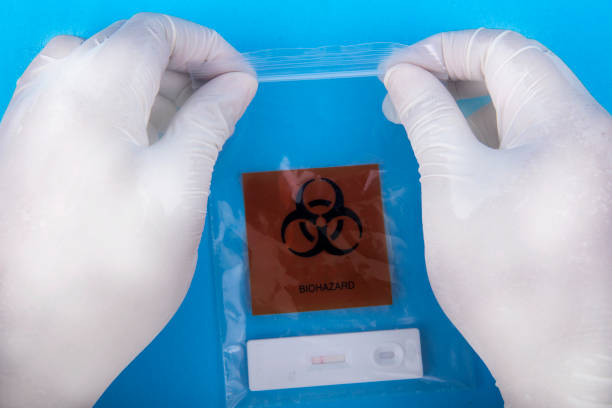istock Health worker hand with protective gloves holding covid-19 antigen test kit 1345087096