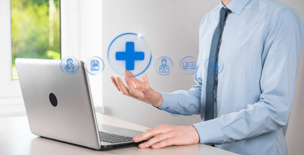 istock Businessman hold virtual plus medical network connection icons. Covid-19 pandemic develop people awareness and spread attention on their healthcare.Doctor,document,medicine,ambulance,patient icon. 1345087340