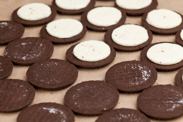istock chocolate cookies with creamy cream filling 1345087696