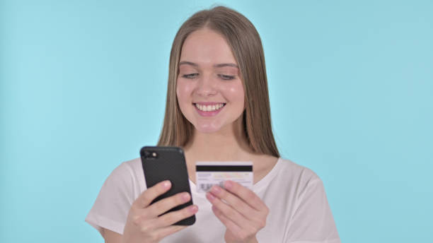 istock Online Payment on Smartphone by Young Woman, Blue Background 1345087985