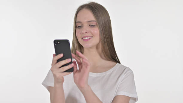 istock Cheerful Beautiful Woman using Smartphone, White Background 1345088213