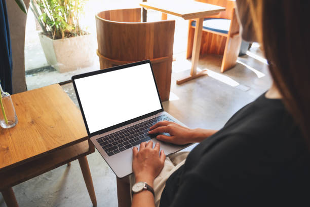 istock a woman using and typing on laptop with blank white desktop screen 1345090620