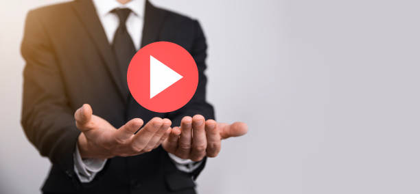 istock Businessman pressing, hold play button sign to start or initiate projects.Video Play Presentation. Idea for business, technology.media player button. Play icon.Go. 1345090761