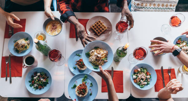 People are sitting at a table and eating. Top view