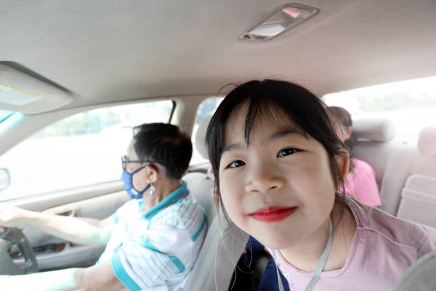 The happy Asian family teaveled by car.