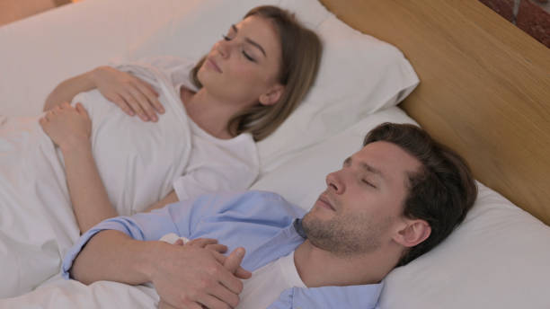 istock Beautiful Young Couple having Nap in Bed 1345094992