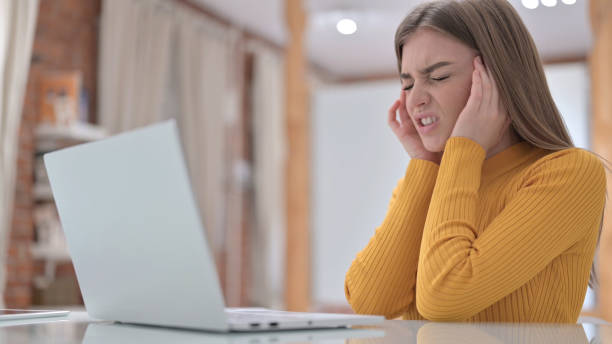 istock Tired Young Woman having Headache in Office 1345095795