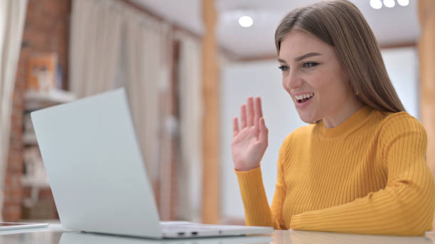 istock Beautiful Young Woman doing Video Chat on Laptop 1345095988