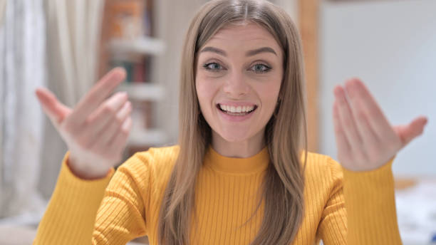 istock Portrait of Creative Young Woman Pointing and Inviting 1345096144