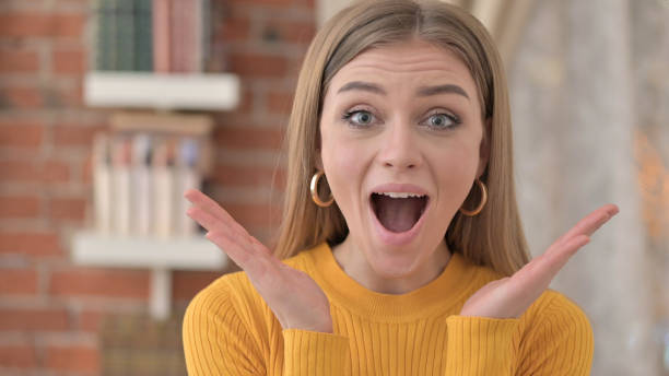istock Surprised Young Woman Feeling Excited for Surprise 1345096437