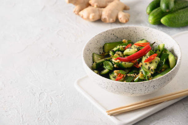 istock Asian spicy cold appetizer Broken Cucumbers with fresh coriander, ginger, pepper chili, black vinegar. 1345096459
