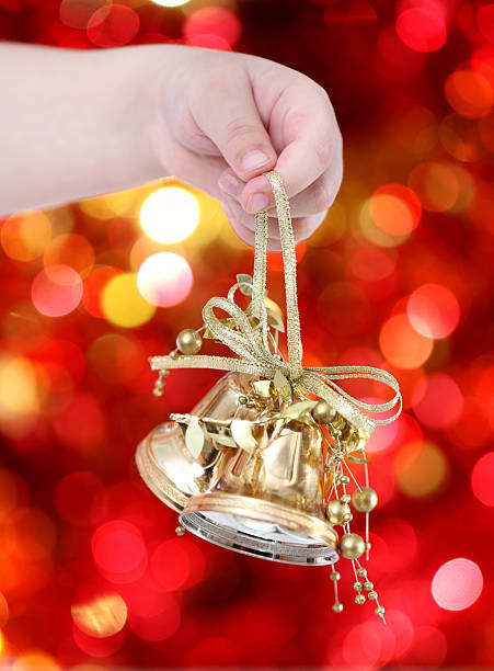 istock Child holding golden Christmas tree decorations 134509772