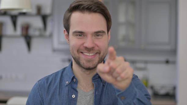 istock Portrait of Beard Young Man Pointing Finger 1345098323