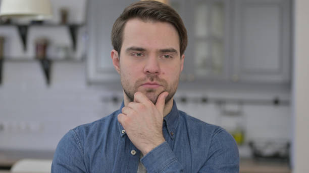 istock Portrait of Young Man Thinking about Creative Idea 1345099209