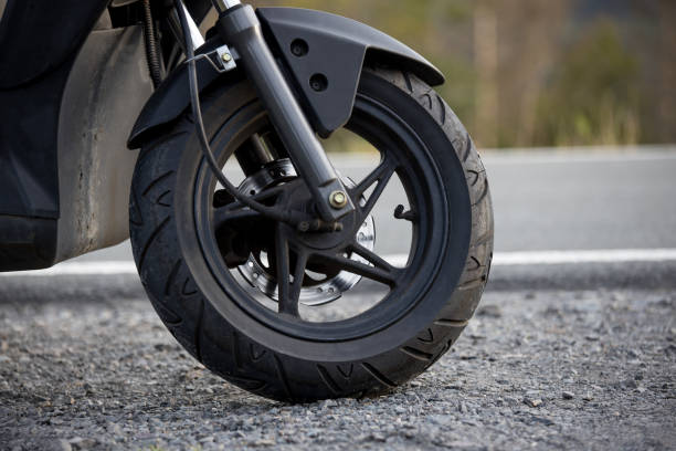 istock a scooter tire in front of a street 1345100108