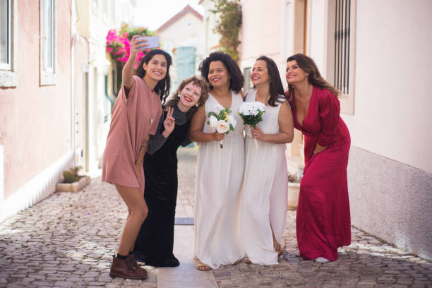 istock Smiling guests and brides taking selfie 1345103402