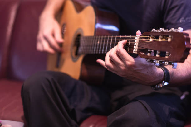 istock Man playing acoustic guitar 1345104999