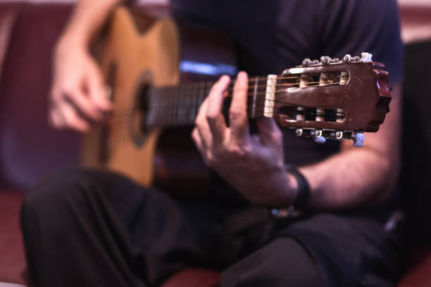 istock Man playing acoustic guitar 1345105215