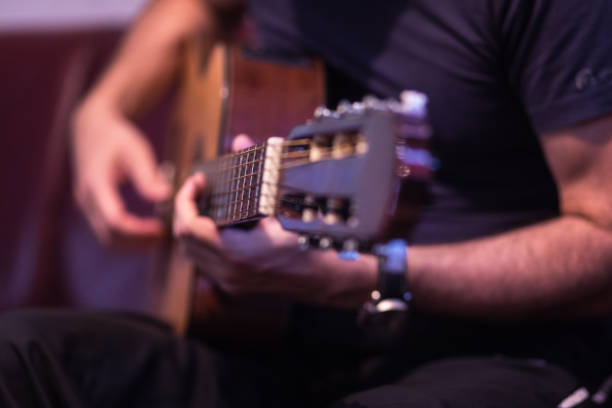 istock Man playing acoustic guitar 1345105296