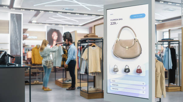 Shot of a Floor-Standing LCD Touch Screen Display with User Interface of Online Clothing Shop Standing in Clothing Store. Self service Checkout with Hand Bag. Diverse People in Shop Buying Clothes. Shot of a Floor-Standing LCD Touch Screen Display with User Interface of Online Clothing Shop Standing in Clothing Store. Self service Checkout with Hand Bag. Diverse People in Shop Buying Clothes. self checkout photos stock pictures, royalty-free photos & images