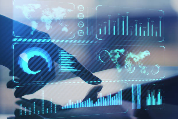 istock Close up of hand using tablet on desktop with creative glowing blue business chart and map hologram on blurry background. Technology, global finance and internet concept. Double exposure. 1345107221