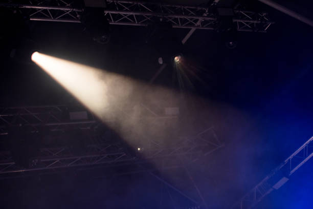 istock Stage lights glowing in the dark 1345108216
