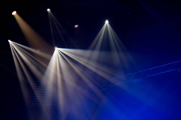 istock Stage lights glowing in the dark 1345108219