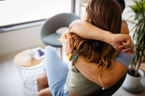istock Romantic happy young couple relax at home, have fun and hugging 1345108703