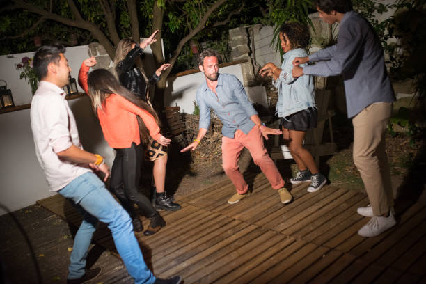 istock Joyful men and women dancing at backyard 1345108834