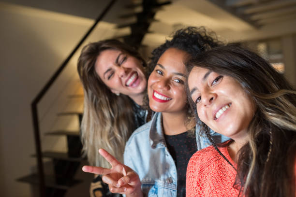 istock Positive female friends taking selfie 1345108845