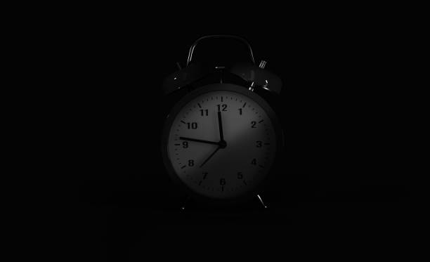 istock vintage alarm clock over black background in he night 1345110459