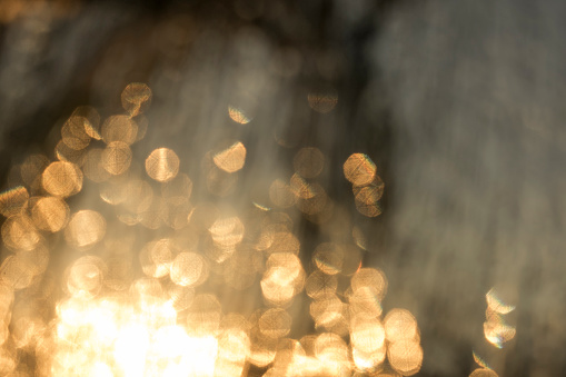 Bokeh of textured glass on golden hour sunset view