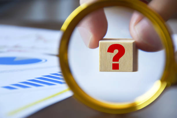 istock Question mark on the wood block with business graphs 1345113124