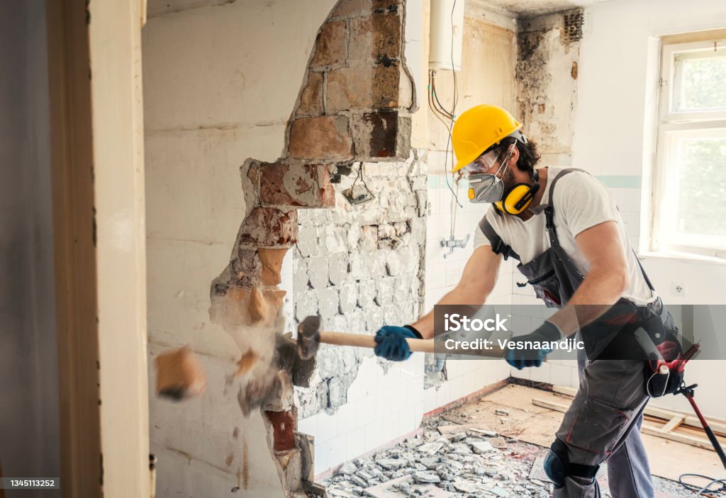 Worker using  hammer Worker using hammer, home renovation Renovation Stock Photo